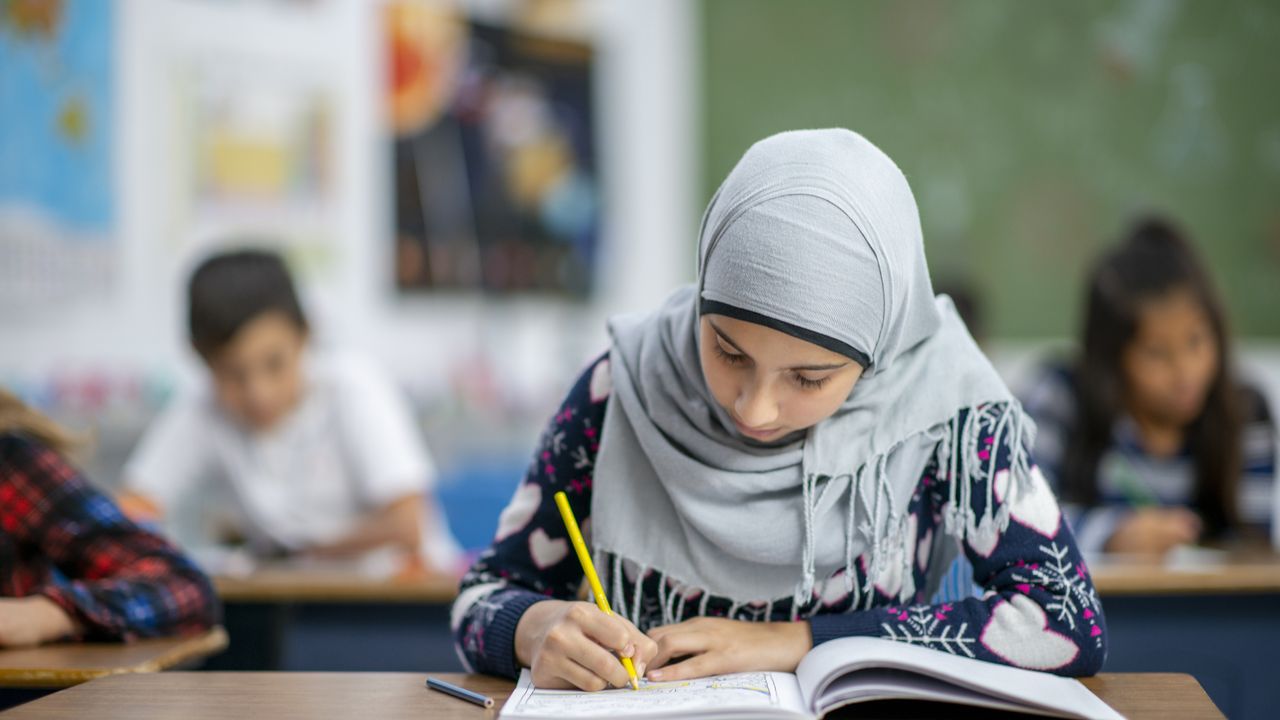Female student wearing headscarf at a European school. iStock.