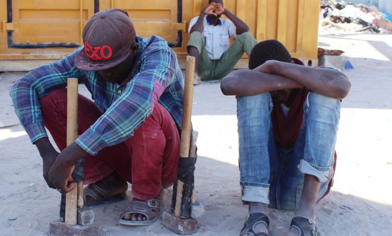 مهاجرون يفترشون جانب الطريق انتظارا لعمل بعد انتشار جائحة كوفيد-19، مصراتة، ليبيا، 2 مايو 2020. رويترز، أيمن الساحلي.