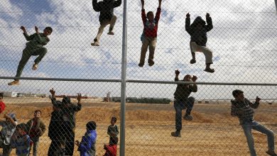 Syrian refugee children climb on a fence to watch a football training workshop in al-Azraq refugee camp, Jordan, 16 November 2015. Reuters, Muhammad Hamed.