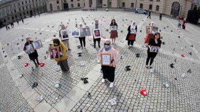 Syrian Women hold portraits and a placard as a call to governments to do more to seek information about detained people in Syria - Berlin, Germany, 28 August 2021. Reuters, Hannibal Hanschke.